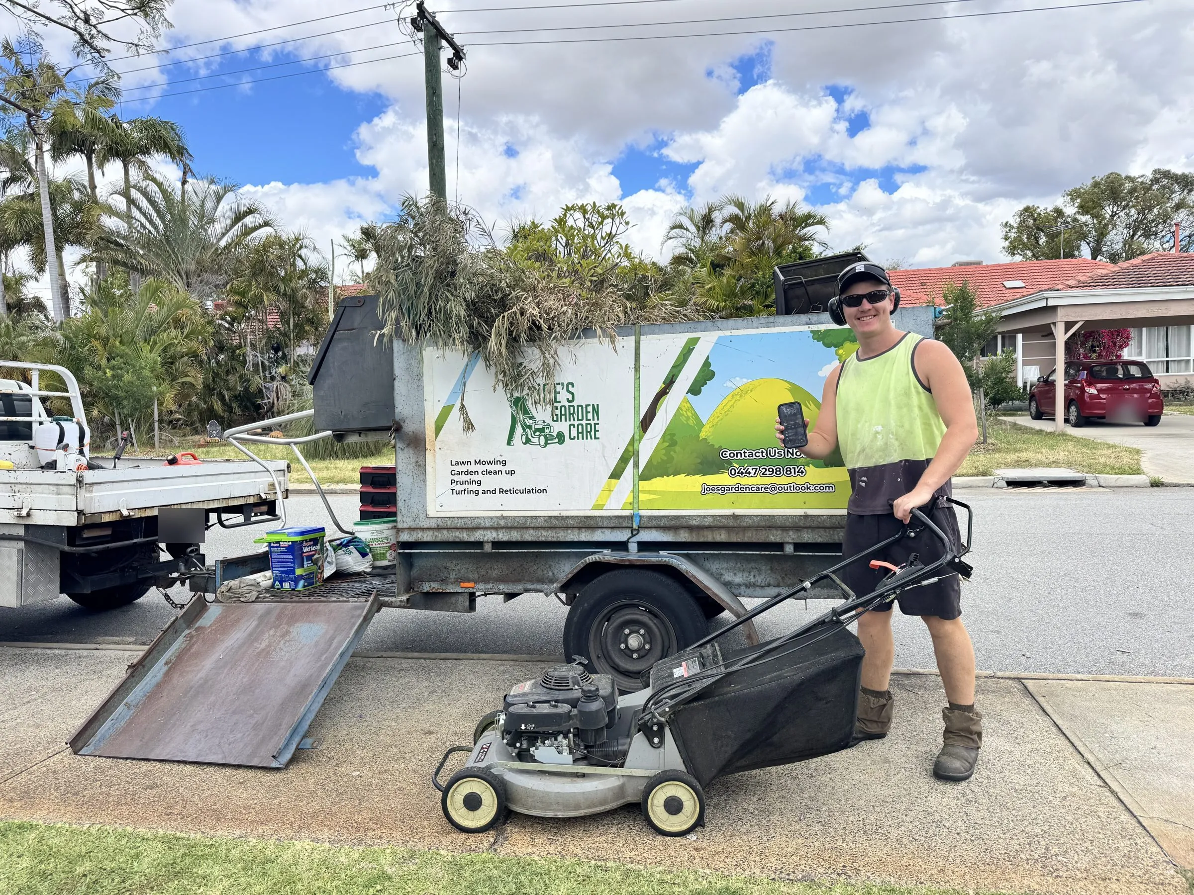 Joe with his mower and trailer, out on the round